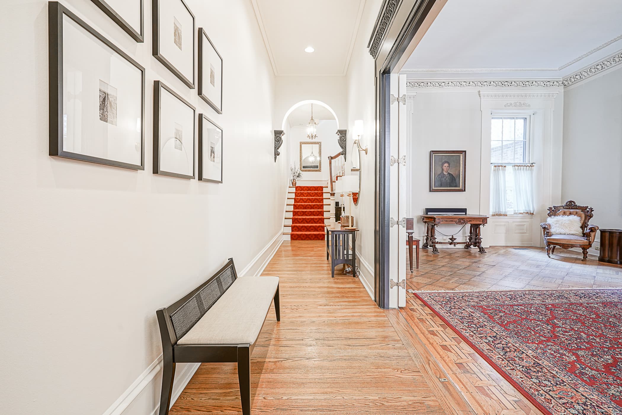 Gallery-hung hallway and staircase inside The Rittenhouse Residence at 1822 Pine Street