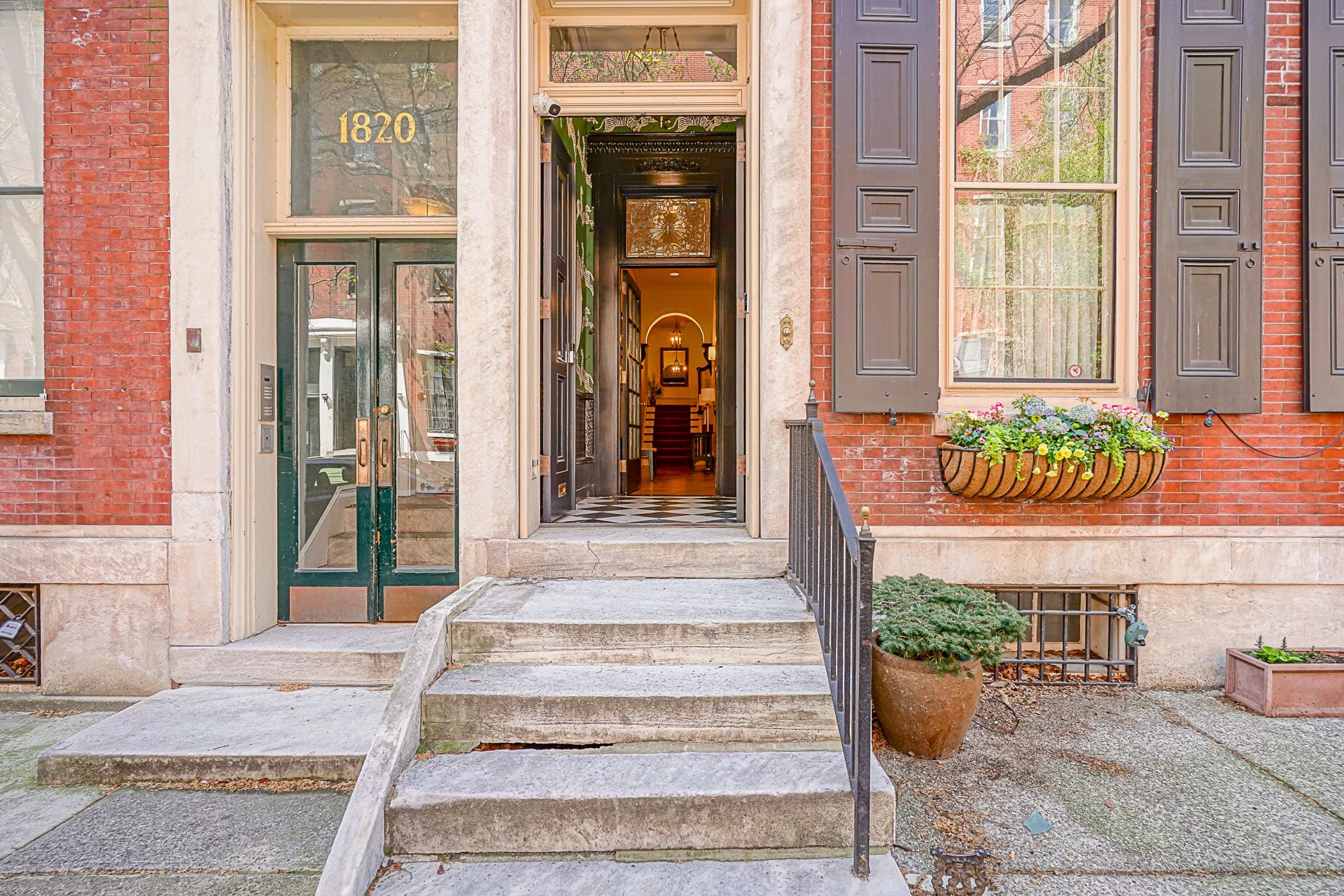 Marble front stoop at The Rittenhouse Residence with the door open to the vestibule