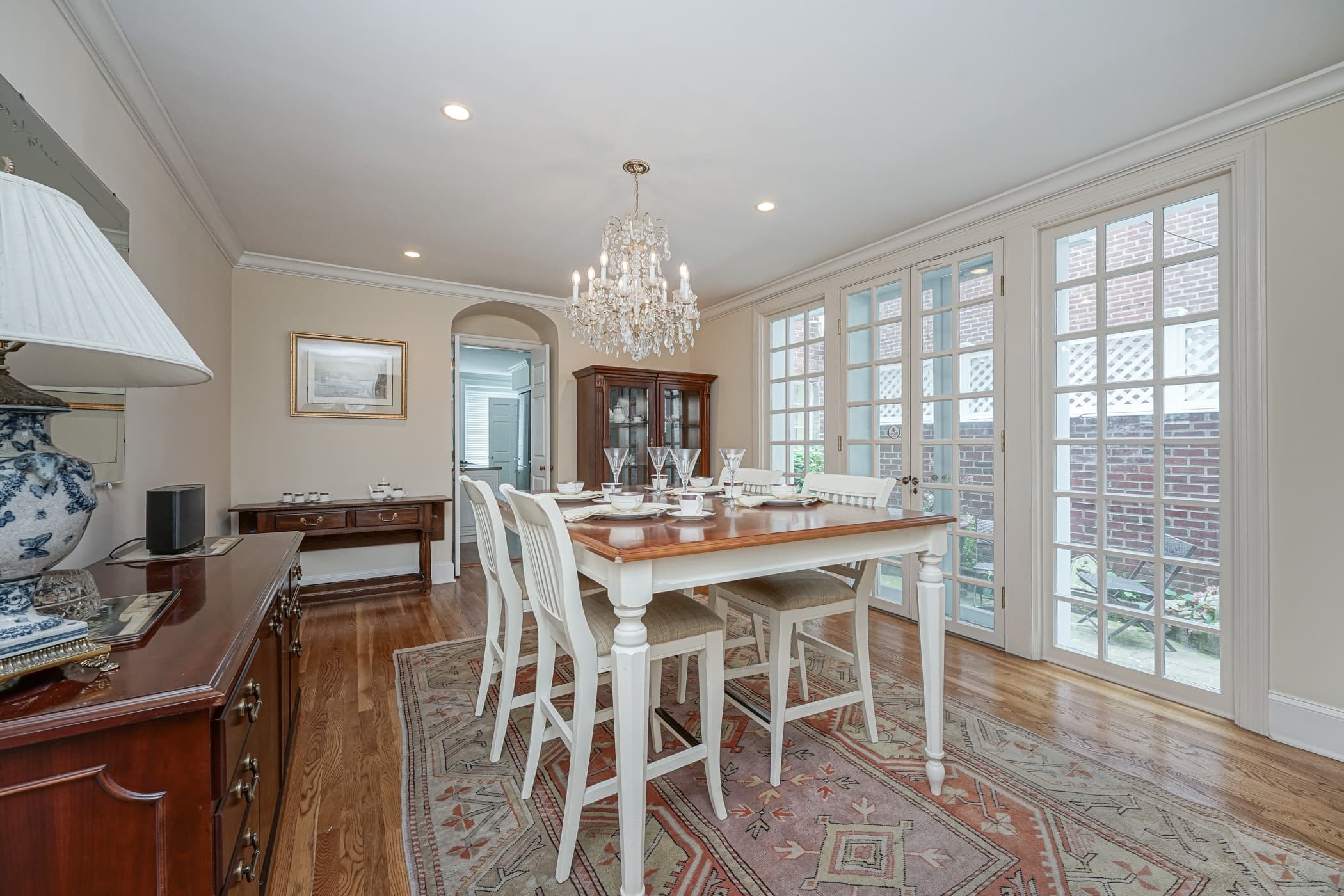 Dining room set for sixteen beneath a crystal chandelier at The Rittenhouse Residence