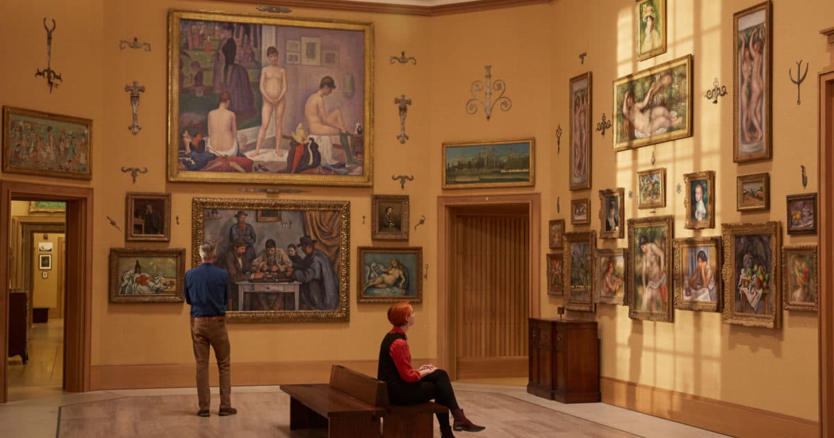 Visitors among salon-style walls of Impressionist masterworks inside the Barnes Foundation galleries